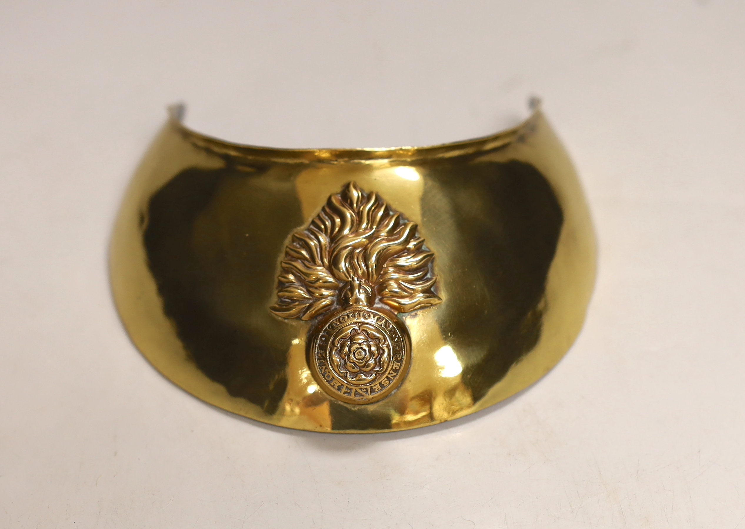 A Royal Fusilliers brass gorget, diameter 12.5cm